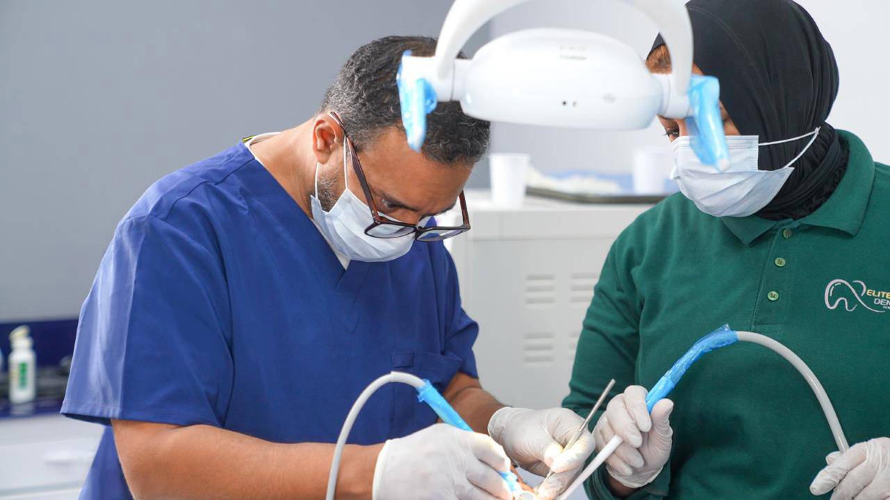 Dr. Ahmed Atteya performing procedure in operating room at Elite Smile Clinics New Cairo